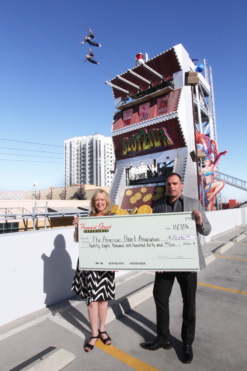 Fremont Street Experience’s Chief Marketing Officer, Paul McGuire, presents an outrageously large check to Debbie Smith, American Heart Association Executive Director.