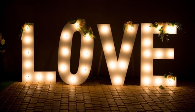 glowing sign saying love with lights