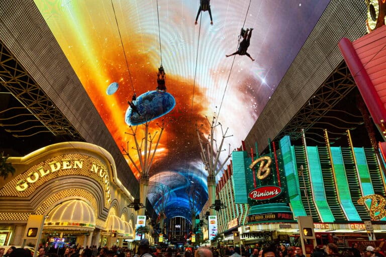 Riders of the Slotzilla zipline at Fremont Street Experience, which is one of the things to do in Las Vegas alone.